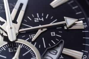 closeup-shot-hands-numbers-hour-marks-black-watch-scaled-1